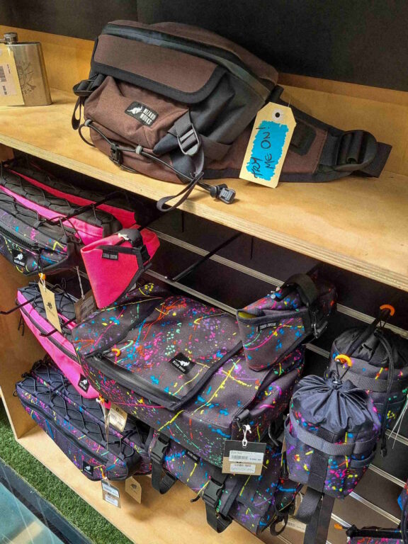 Wizard Works colourful Bike Bags display on wooden counter at Melbourne bike shop Commuter Cycles